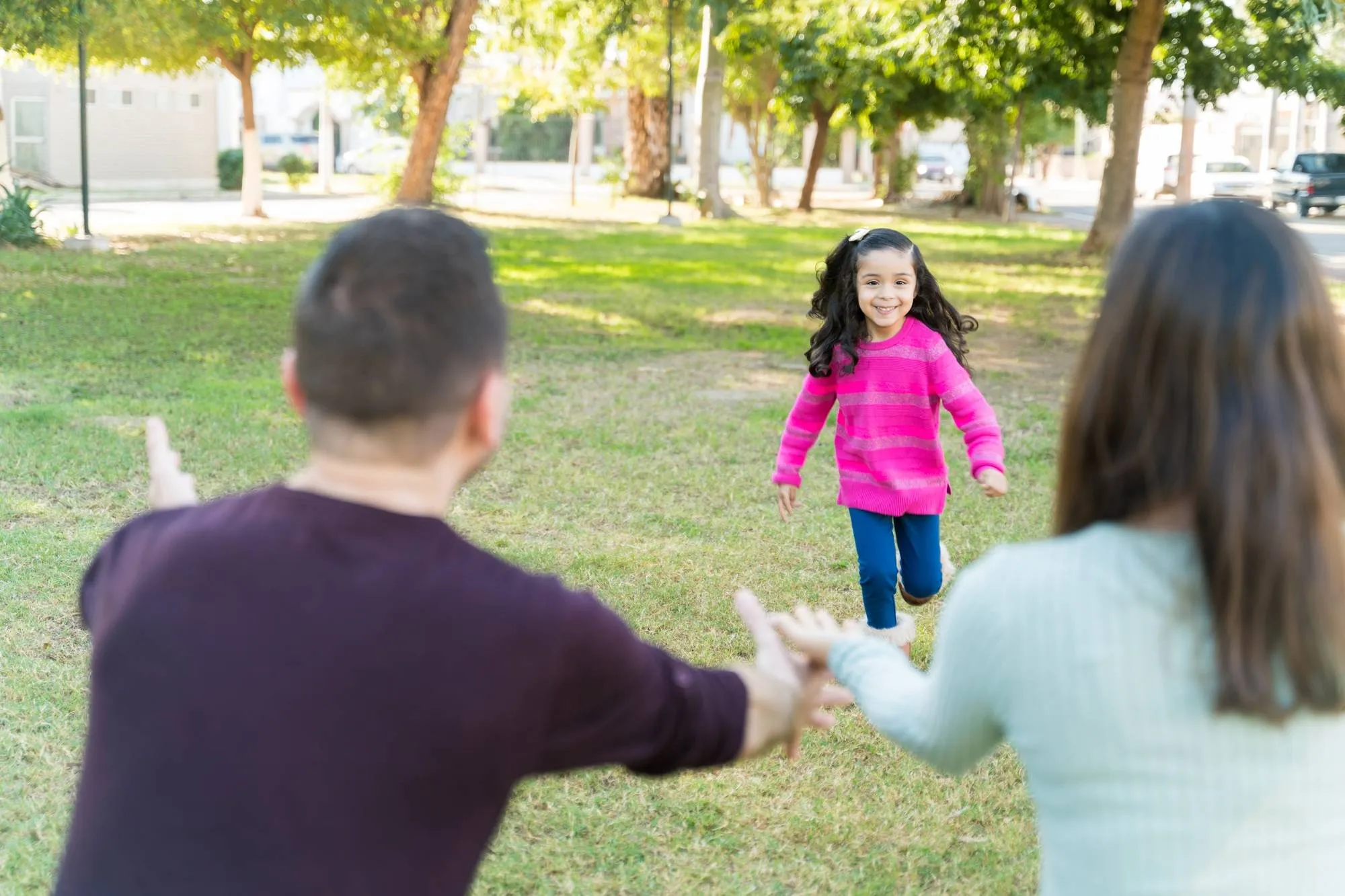 Girl Having Fun Parents At Park