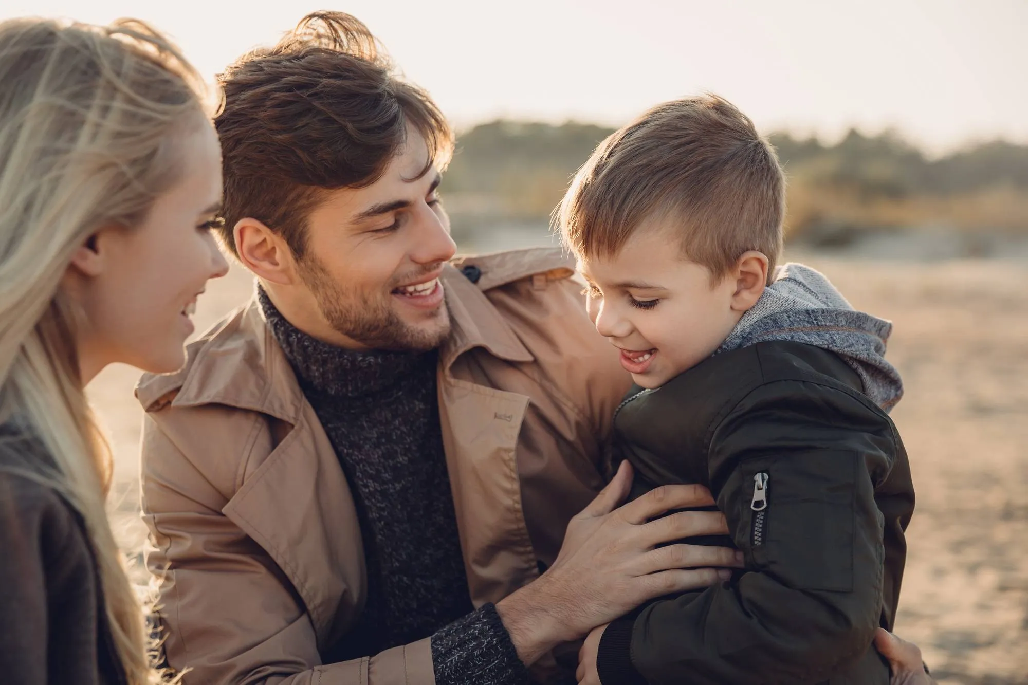 smiling parents with son spending time together